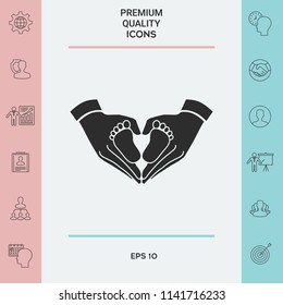 Hands holding baby - protection symbol. Heart shape made with hands