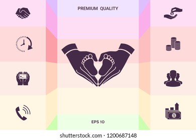 Hands holding baby - protection symbol. Heart shape made with hands