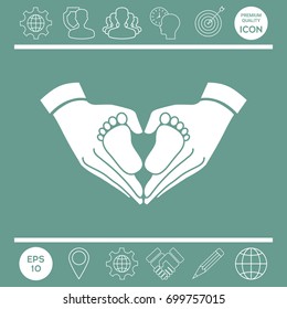 Hands holding baby - protection symbol. Heart shape made with hands