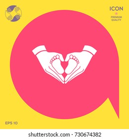 Hands holding baby - protection symbol. Heart shape made with hands