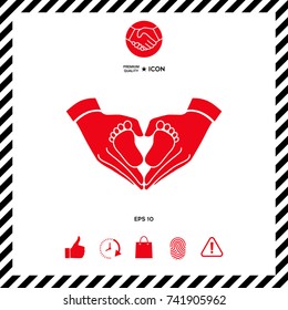 Hands holding baby - protection symbol. Heart shape made with hands