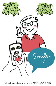 Hands holding camera phone with senior cheerful man smiling and posing displayed on screen. Mobile photography concept with hands holding smartphone taking a photo of cute happy elderly man.