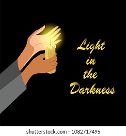 hands holding a candle in the dark