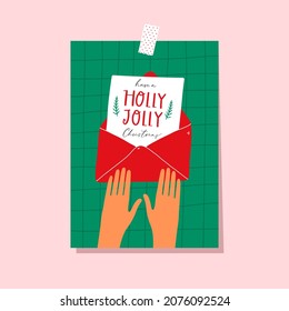 Hands holding Christmas postcard. Holiday print, banner, gift tag. 