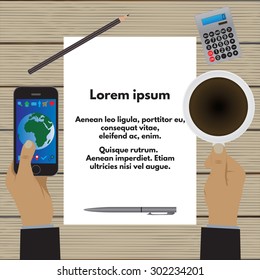 Hands holding a cup of coffee and a smartphone over a wooden table. A sheet of paper with text, images, graphics, etc. Business concept. Business morning, lunch. Top view.