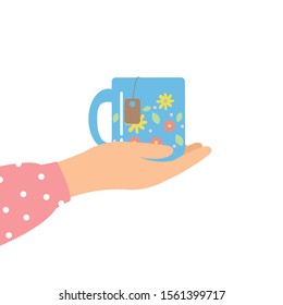 Hands holding a cup of tea and beautiful cup.