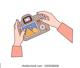Hands holding digital camera flat vector illustration. Professional photographic equipment in photographer arms. Photo studio worker, paparazzi accessory. DSLR with picture preview on display.