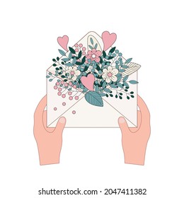 Hands holding an envelope with flowers. Waiting, surprise, gift, invitation to a holiday, receiving a gift, giving joy