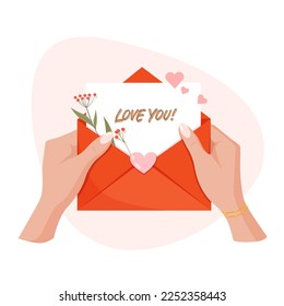 Hands holding envelope with hearts and text Love you. Concept for Valentine's Day