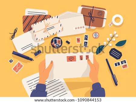 Hands holding envelope with stamps surrounded by papers, postcards, pen on yellow background. Top view. Postcrossing, sending letters through postal service. Flat cartoon vector illustration