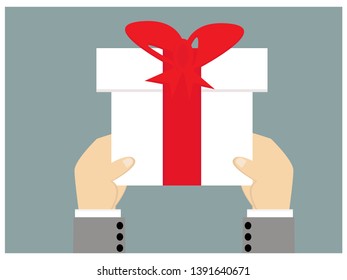 Hands holding a gift box isolated on background
