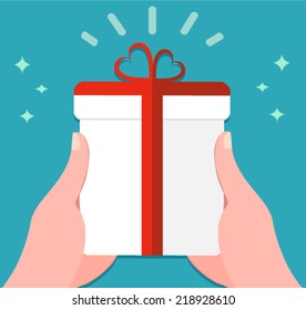 hands holding a gift box with a ribbon - flat design vector 