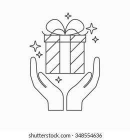 Hands holding a gift. Festive gift. A poster for the shop window. Promotions / discounts / gifts.