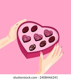 Hands are holding a gift for Valentine's Day. A box of chocolates in the form of a heart, a gift for loved ones. Candies on a pink background in the package. A woman is holding candy