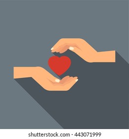 Manos sosteniendo un icono cardíaco en estilo plano con una sombra larga. Símbolo de amor y relación