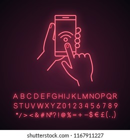 Hands holding NFC smartphone neon light icon. NFC phone. Near field communication. Mobile phone contactless payment. Glowing sign with alphabet, numbers and symbols. Vector isolated illustration
