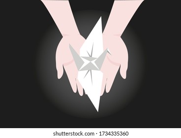 Hands holding origami bird as symbols