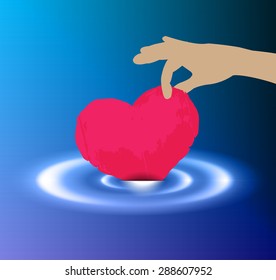 Hands holding paper pink heart. Waves on dark blue water from falling drop. pick. catch. be drowned