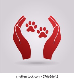 Hands holding paws - animal protection icon.