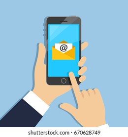 Hands holding phone with mail icon on screen