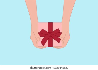 Hands is holding the pink gift box with red ribbon. greeting season and celebration on holiday. Love, enjoy sharing, birthday concept. 