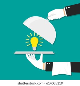 Hands holding platter with idea light bulb