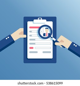 Hands holding a resume and learn it through a magnifying glass, the employer is considering job candidates resume. business concept job interview