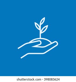 Hands holding seedling in soil line icon. Stock Vector