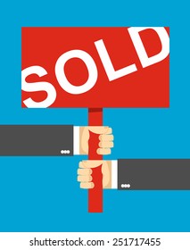 hands holding a sign. Sold text.  