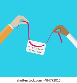 hands holding a silk red ribbon with the sign. interracial couples theme