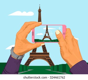 Hands holding smart phone taking a snapshot of Eiffel Tower