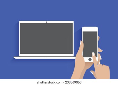 Hands holding smartphone with blank screen. Smartphone is connected to laptop. Touching blank screen. 