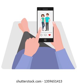 Hands holding smartphone, lying on couch. View beautiful photos