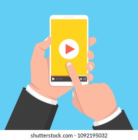 Hands holding smartphone and touching screen. Video player on screen. Vector illustration.