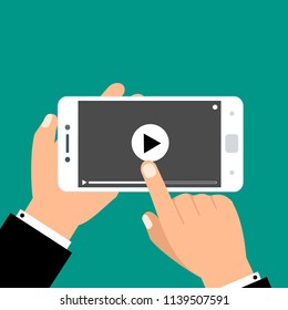 Hands holding smartphone and touching screen. Video player on screen. Vector illustration.