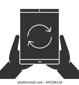 Hands holding tablet computer glyph icon. Device synchronization. Silhouette symbol. Tablet computer with cycling arrows. Negative space. Vector isolated illustration
