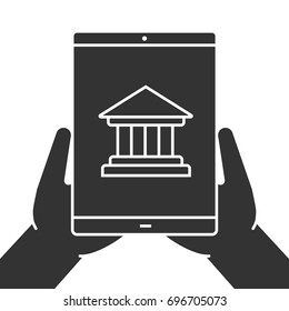 Hands holding tablet computer glyph icon. Internet banking. Silhouette symbol. Tablet computer with bank building. Negative space. Vector isolated illustration