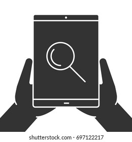 Hands holding tablet computer glyph icon. Silhouette symbol. Tablet computer with magnifying glass. Negative space. Vector isolated illustration