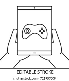 Hands holding tablet computer linear icon. Playing games. Thin line illustration. Tablet computer with gamepad. Contour symbol. Vector isolated outline drawing. Editable stroke