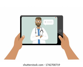 Hands holding a tablet with a doctor with a stethoscope, therapist talking in the messenger and online consultation, video review. Ask a doctor. Medical consultation or online consultation