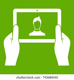 Hands holding tablet icon white isolated on green background. Vector illustration