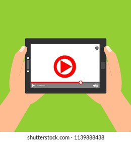 Hands holding tablet with video player on screen. Vector flat illustration