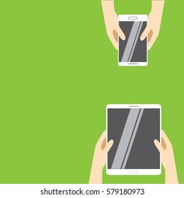 Hands holding white tablet computer and white smartphone on a green background. Vector illustration in flat design. Concept for web design, promotion templates, infographics. vector illustration