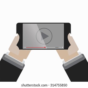 Hands holing Smartphone with video player on the screen