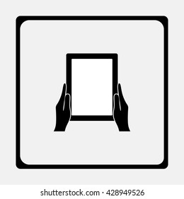 Hands holing tablet computer with blank screen.