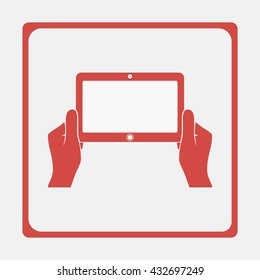 Hands holing tablet computer with blank screen.