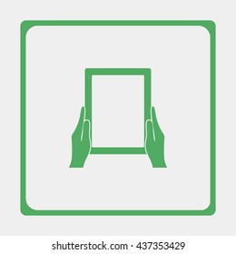 Hands holing tablet computer with blank screen.