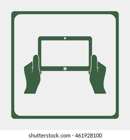 Hands holing tablet computer with blank screen.