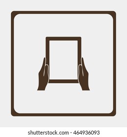 Hands holing tablet computer with blank screen.