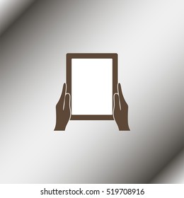 Hands holing tablet computer with blank screen.